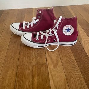 Maroon high top all-star converse
